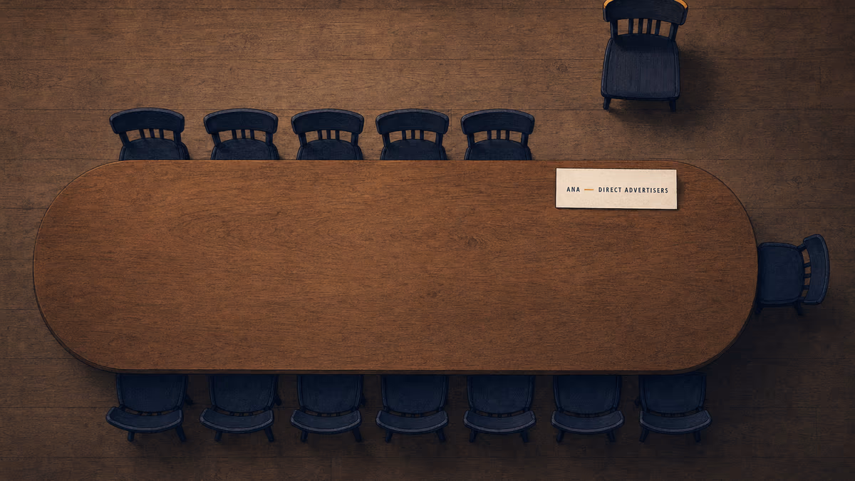 Overhead editorial illustration of a long oval council table with 13 occupied navy chairs arranged around its sides and a 14th chair at the head left conspicuously empty, the empty seat marked by a small letterpress place card reading 'ANA · DIRECT ADVERTISERS' on warm ivory paper.